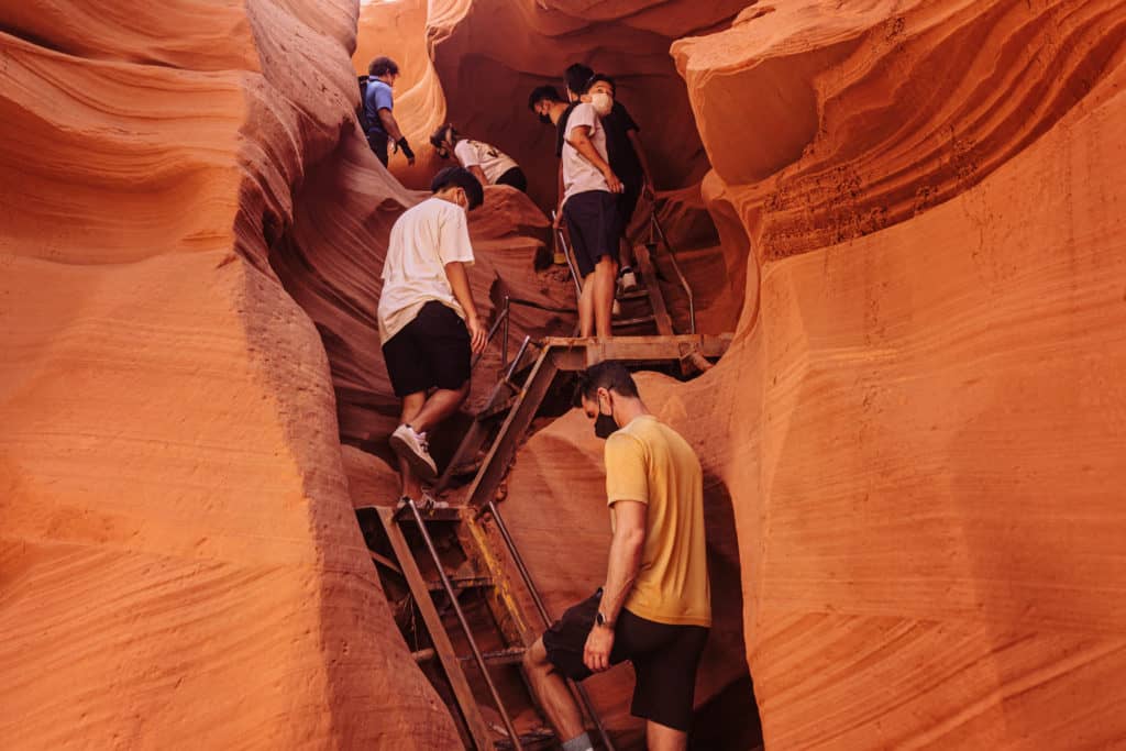 Climbing stairs inside Lower Antelope Canyon