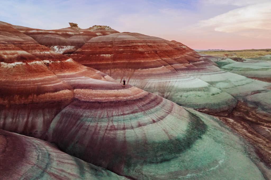 Bentonite Hills, Utah, are in a remote part of the state.  These are the famous rainbow mountains of Utah, which are best seen around sunset, during "blue hour" from a drone.