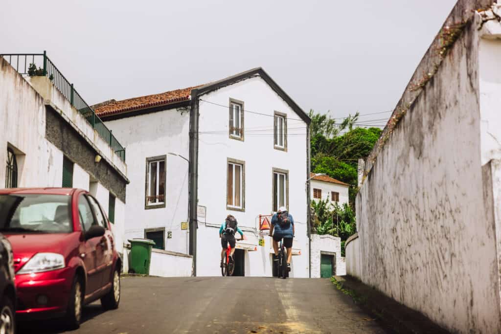 Cyclists on the road, while driving a rental car in the Azores
