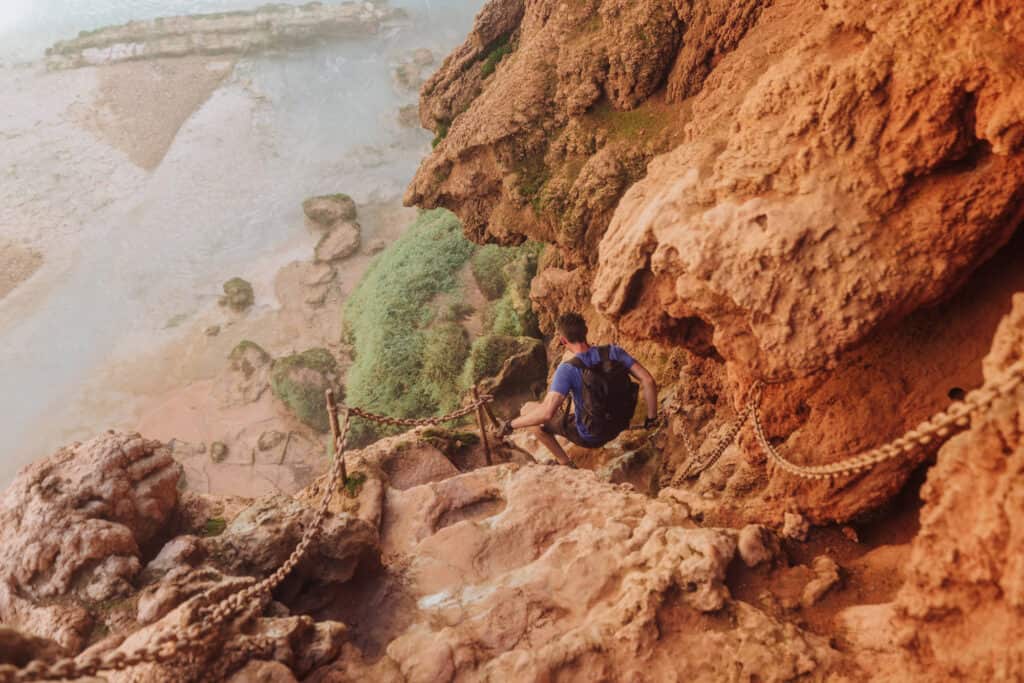 Jared Dillingham climbing down Mooney Falls rocks