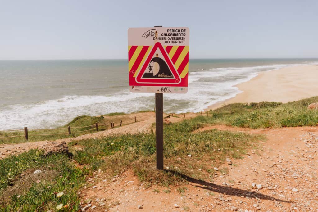 Warning sign of big waves at Praia do Norte in Nazare