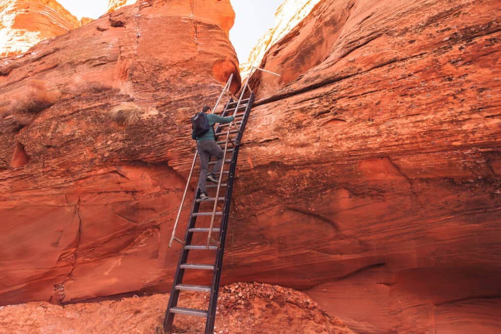 Jared Dillingham climbing down a ladder at Cardiac Canyon
