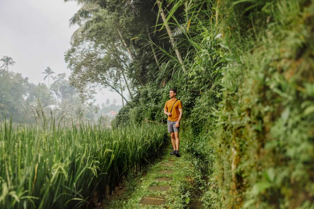 Jared Dillingham walking though Bali's rice terraces