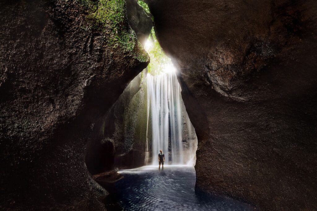 A man at Bali's Tukad Cepung waterfall