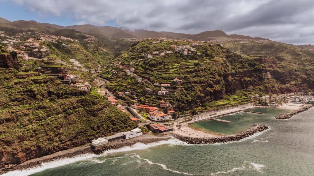An aerial drone view of Calheta, a town to stop in on a Madeira road trip