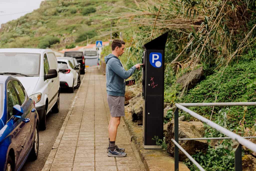 Jared Dillingham paying for street parking in Porto Moniz Madeira