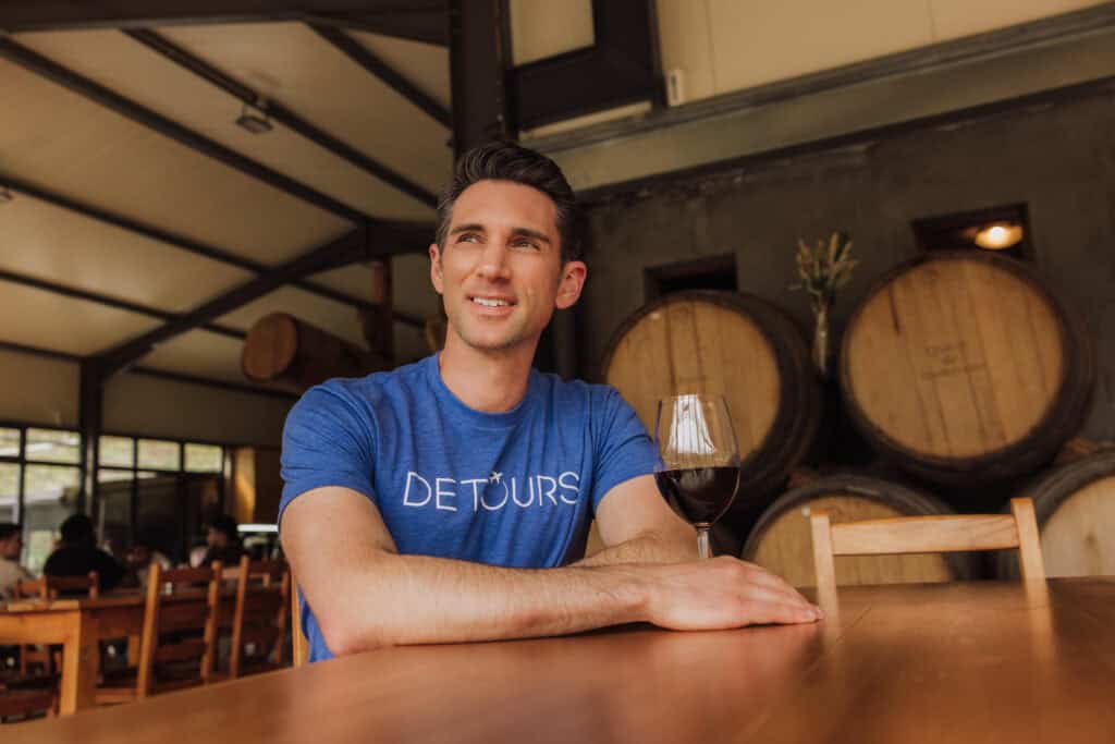 Jared Dillingham having a glass of red wine at a tasting on Madeira