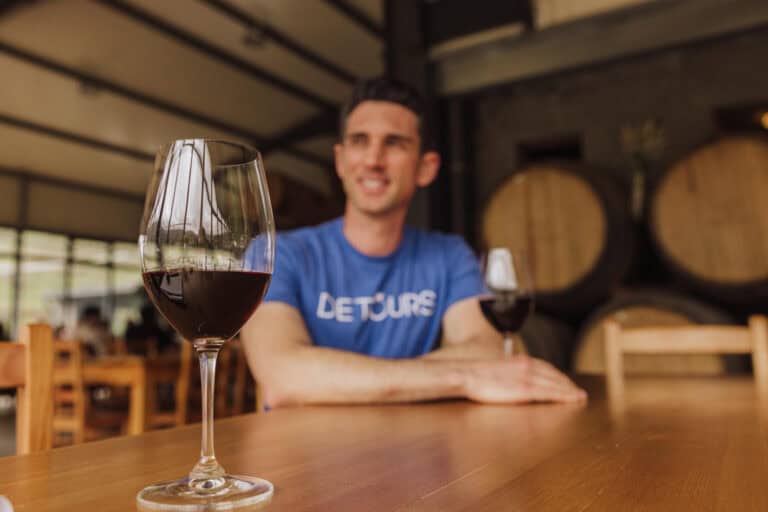 Jared Dillingham having a glass of red wine at a Madeira winery