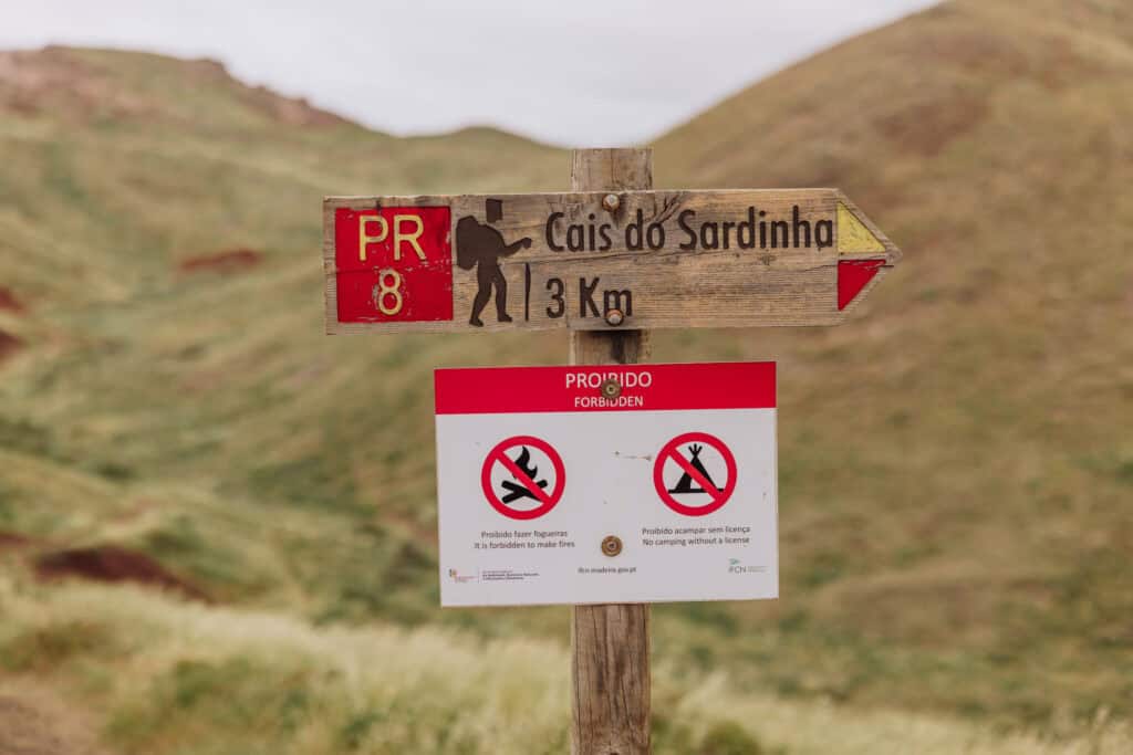 The sign says no camping along PR8