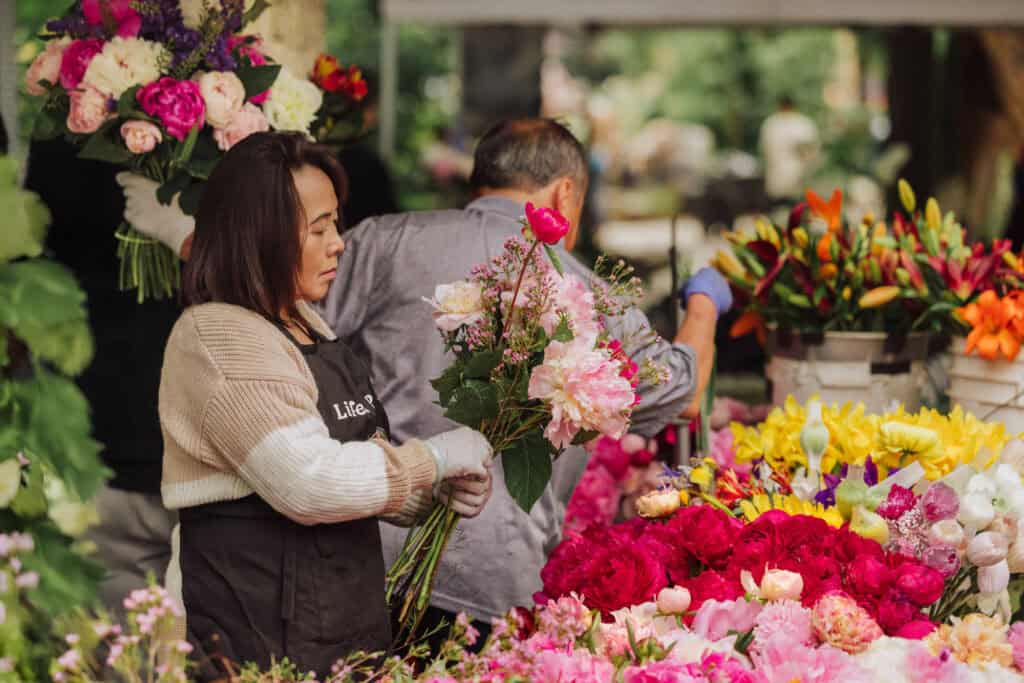 Florists putting together bouquets at the market