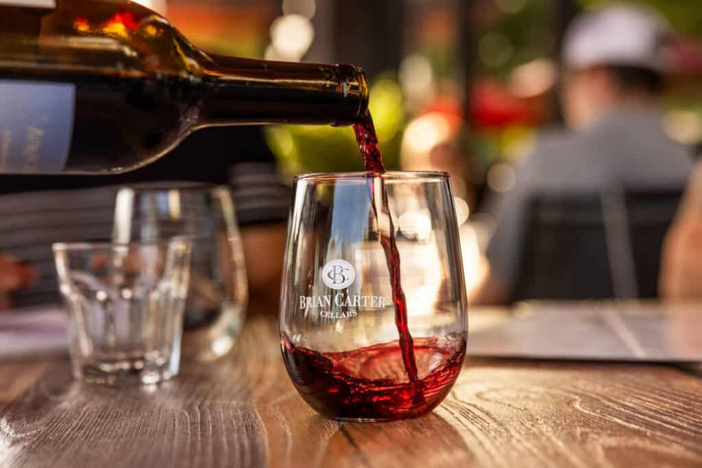 Having a glass of red wine at Brian Carter Cellars on the waterfront