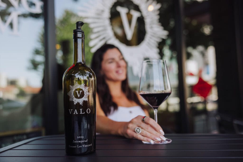 Having a glass of red wine on the patio of Valo Winery