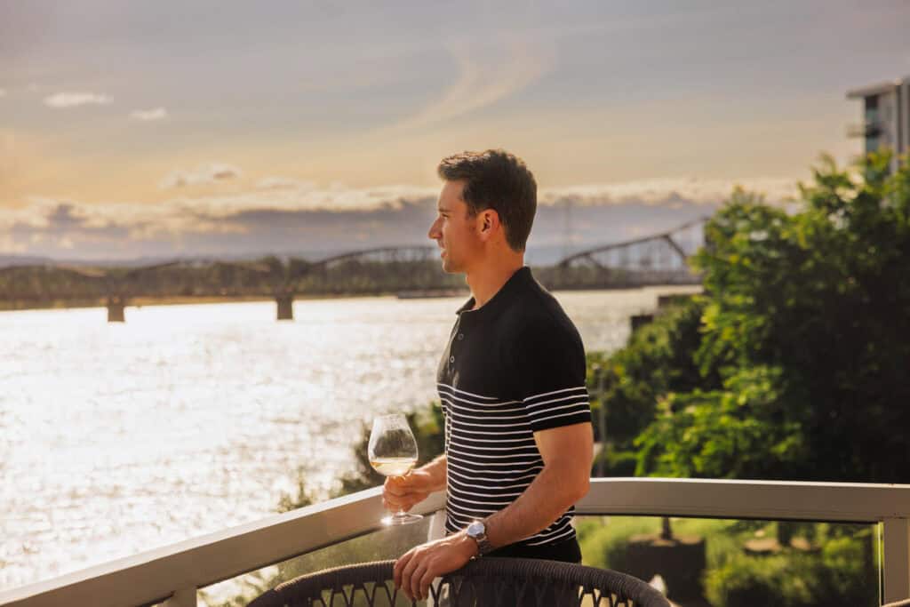 Jared Dillingham having a glass of wine on the patio of