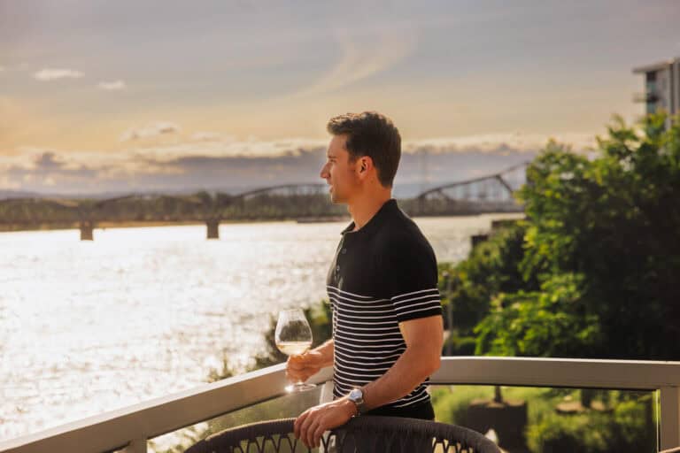 Jared Dillingham having a glass of wine on the patio of