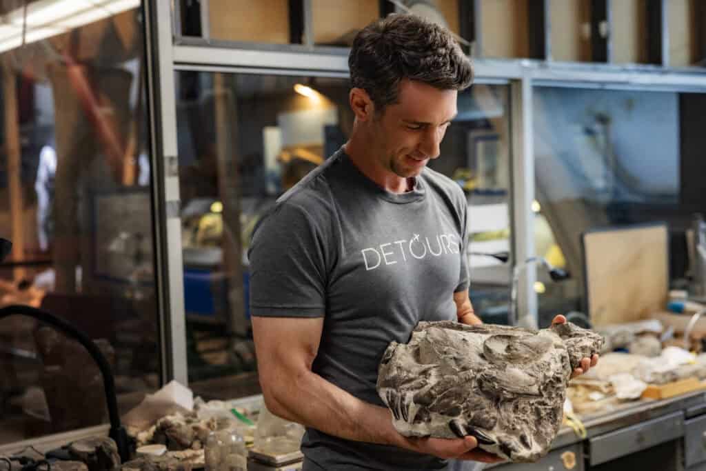 Jared Dillingham holding the front nose of a Tyrannosaur in Montana
