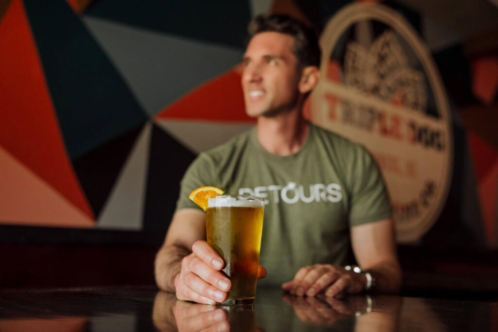 Jared Dillingham having a pint of beer at Triple Dog Brewing