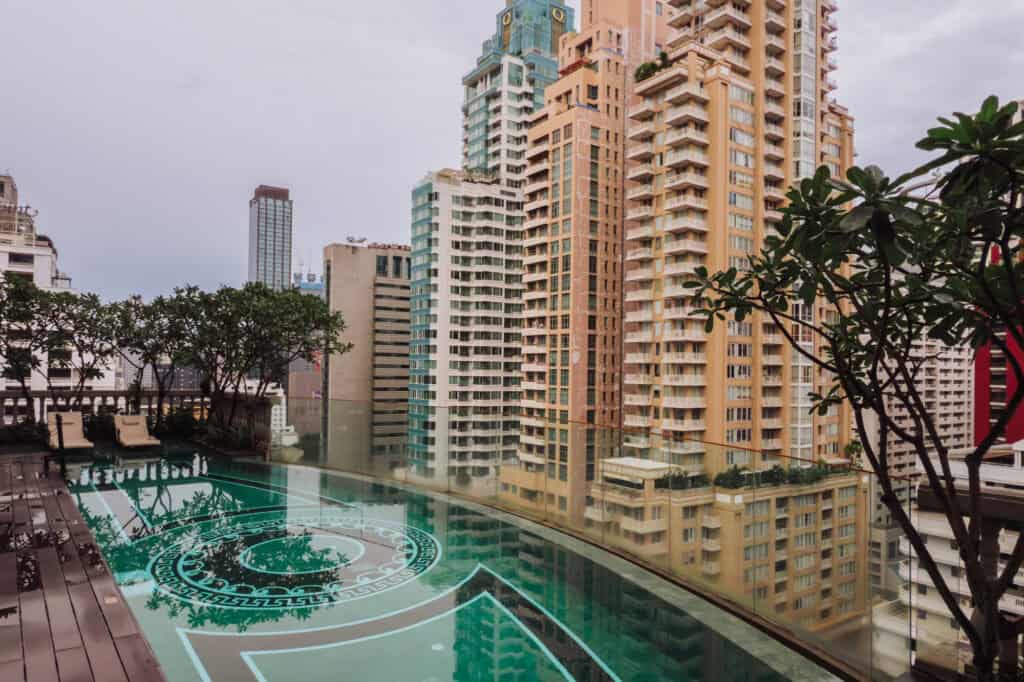 The rooftop pool at the Hotel Muse, with a view of the Bangkok skyline