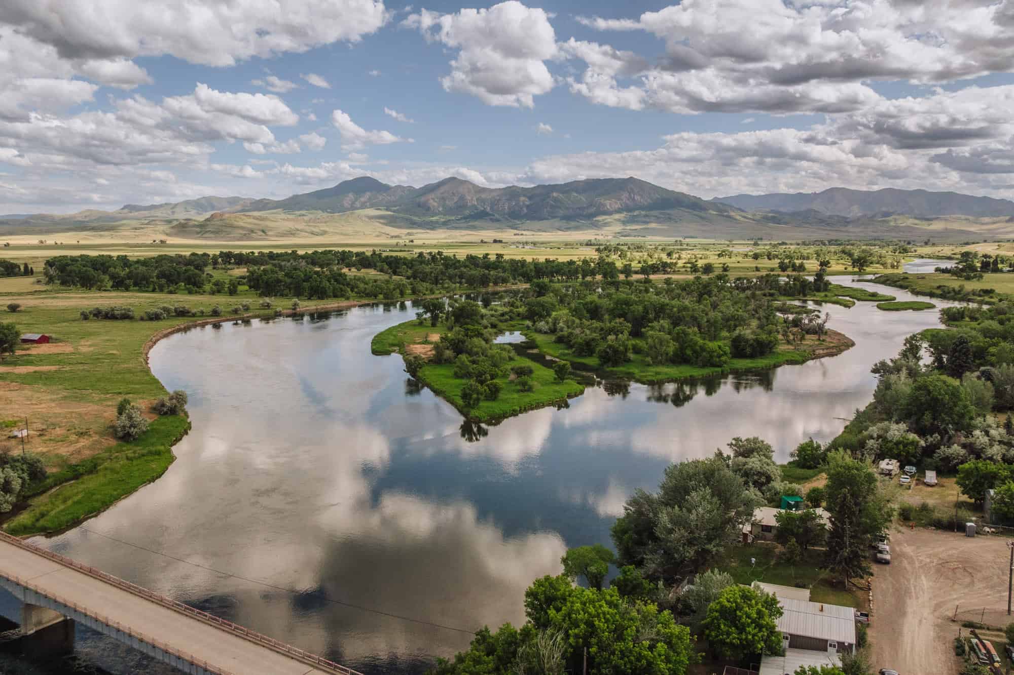 An aerial drone view of the Missouri River reflecting the Big Sky clouds in Montana