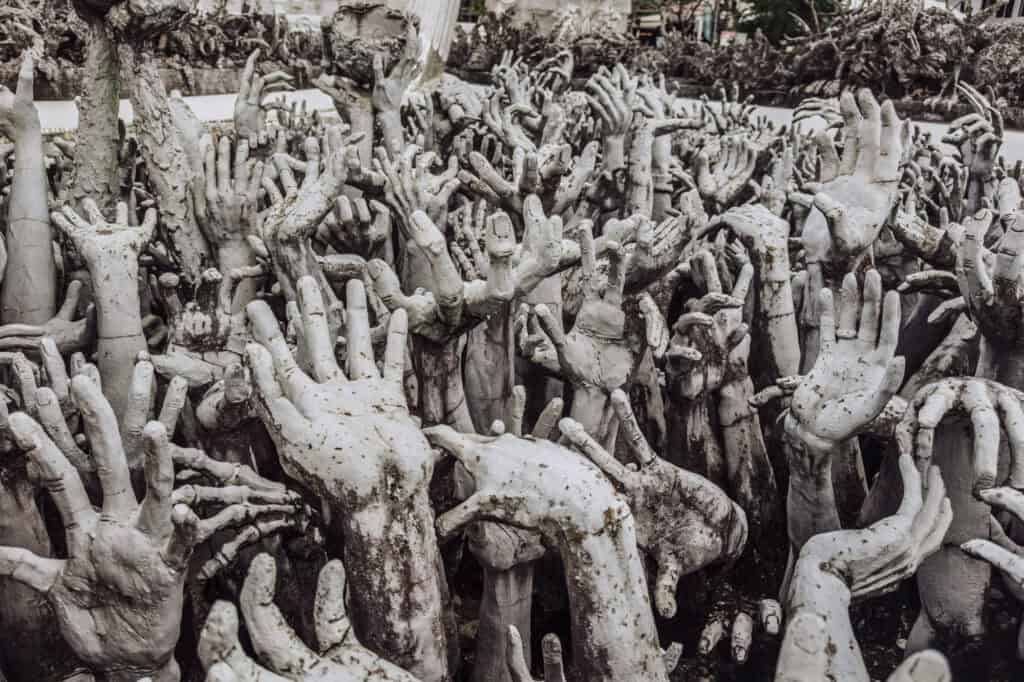 The hands reaching up from hell at the temple