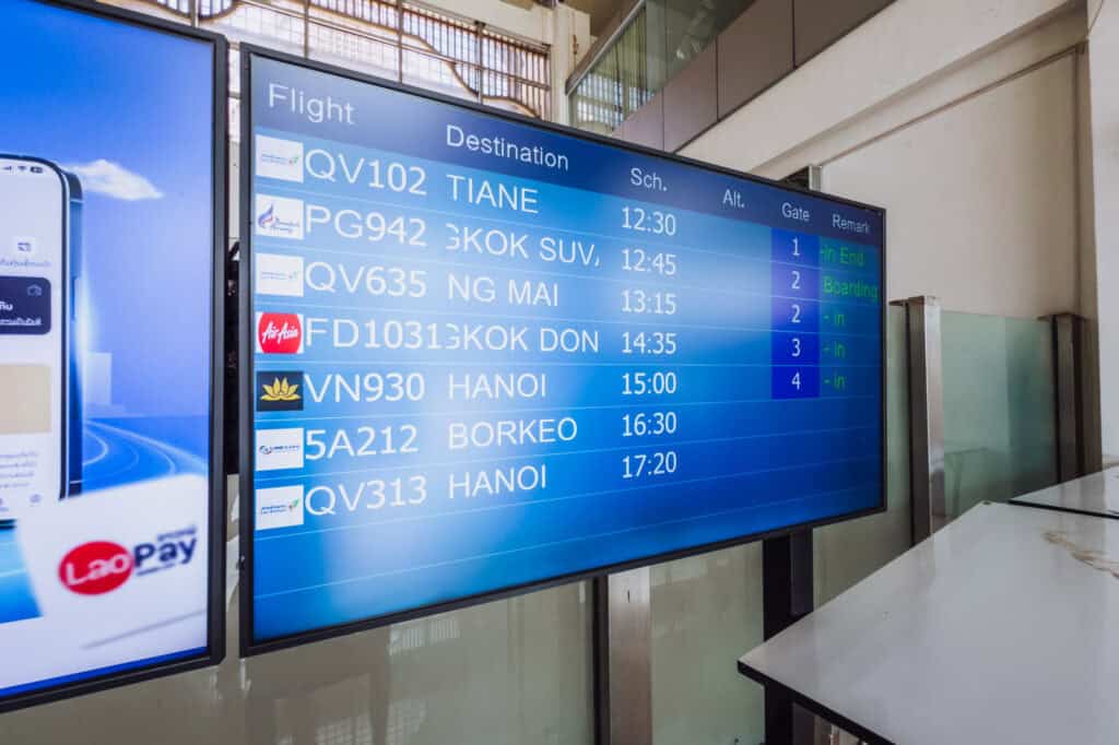 An airport flight status board in Luang Prabang