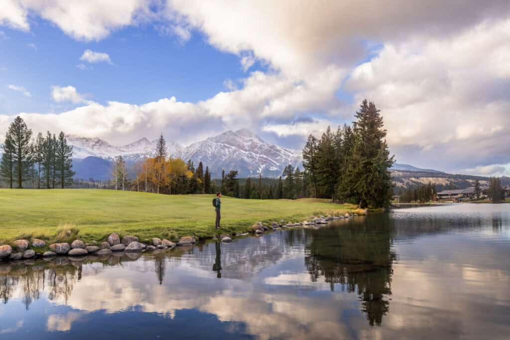 The lake reflecting the sky at the Fairmont Jasper Park Lodge in Alberta
