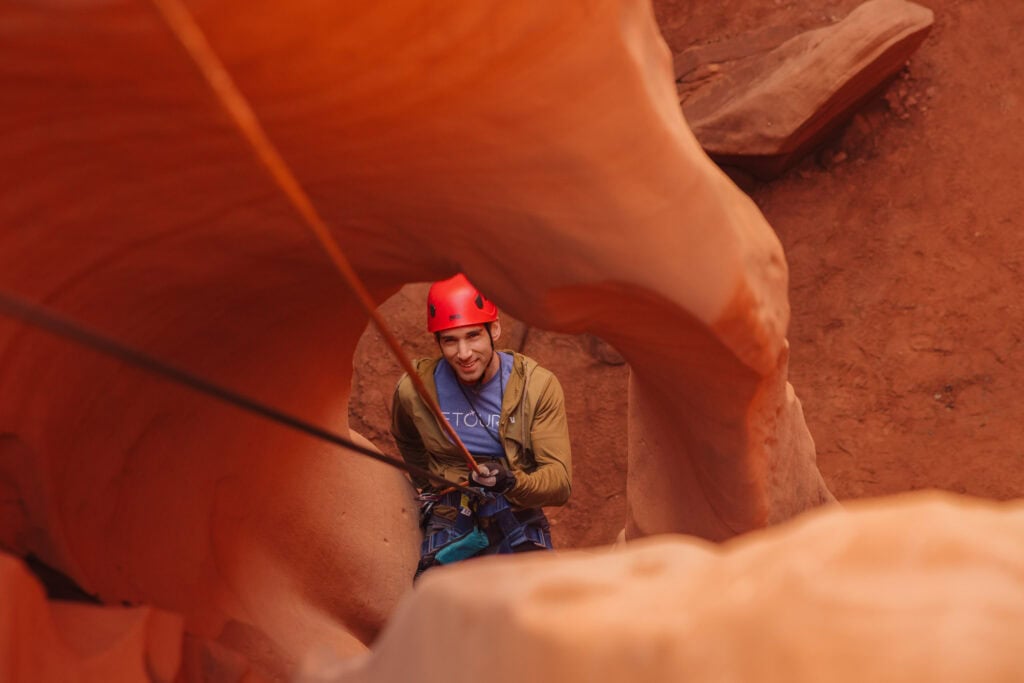 Jared Dillingham rappelling into Antelope Canyon in AZ