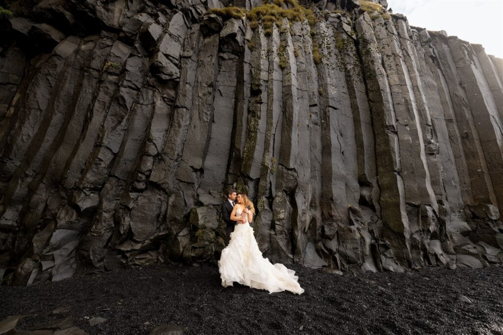 A wedding on the black sand beach in Iceland, Reynisfjara, which eroded