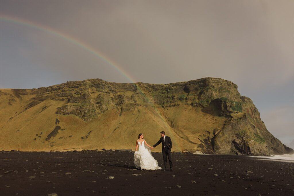 A bride and groom at their wedding on Iceland's black sand beach, Reynisfjara