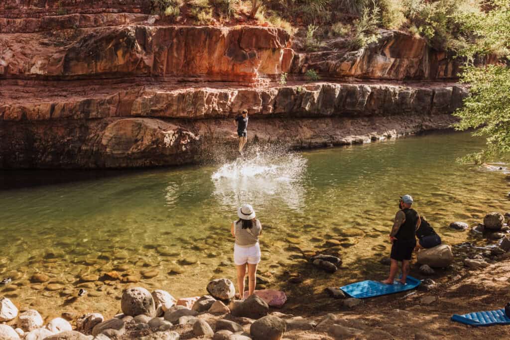 People swimming in Oak Creek, at Grasshopper Point