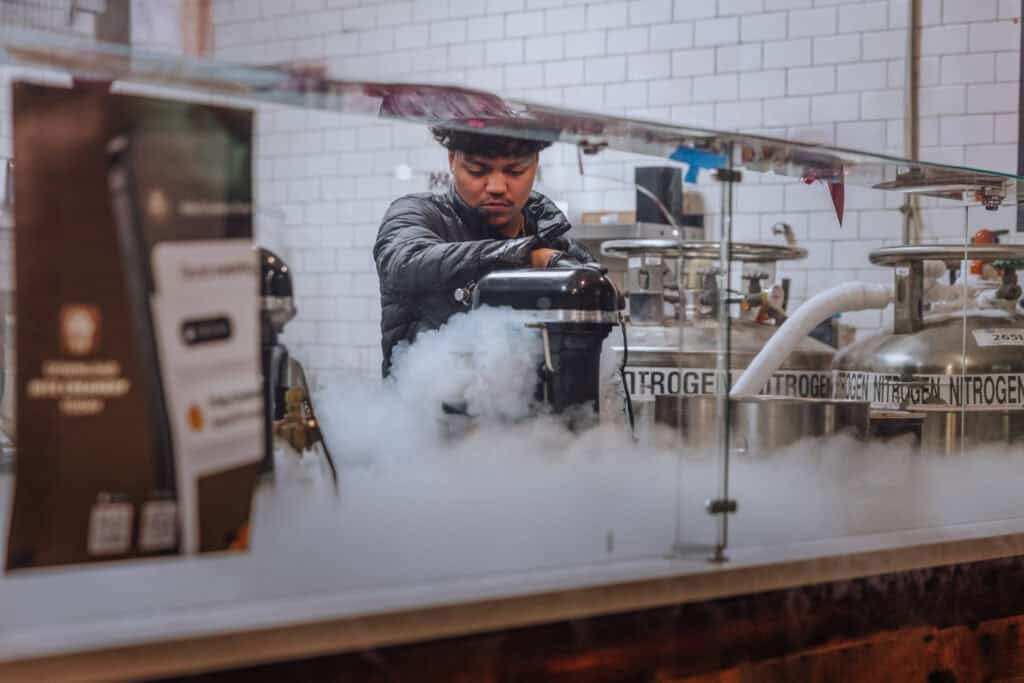 A worker at Nite Creamery using liquid nitrogen to make a unique ice cream