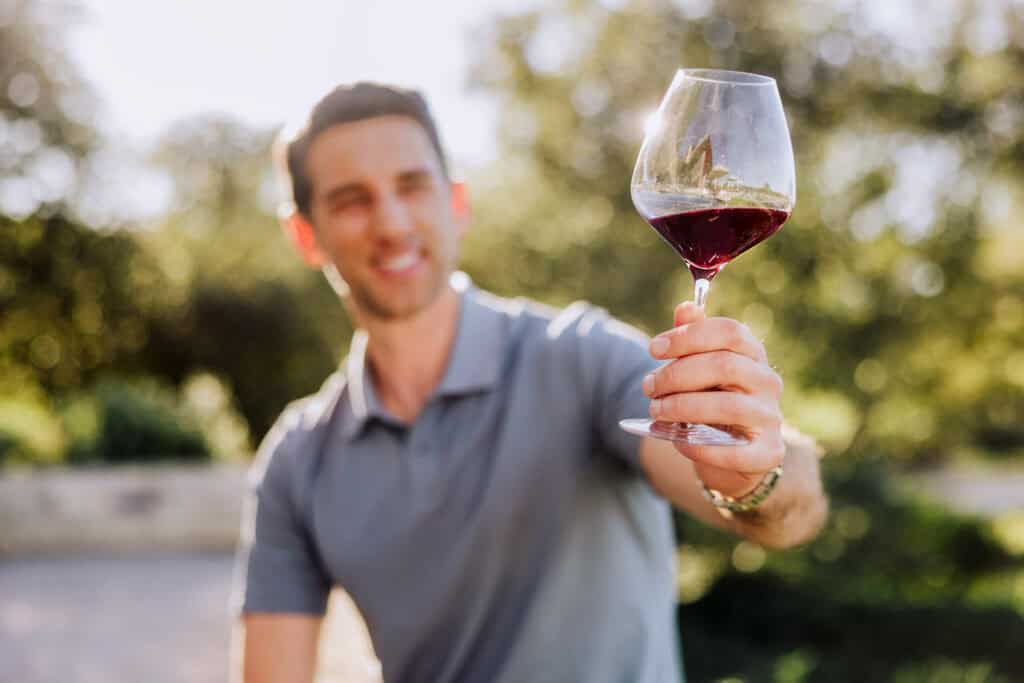Jared drinking a glass of pinot noir at a tasting at Presqu'ile Winery