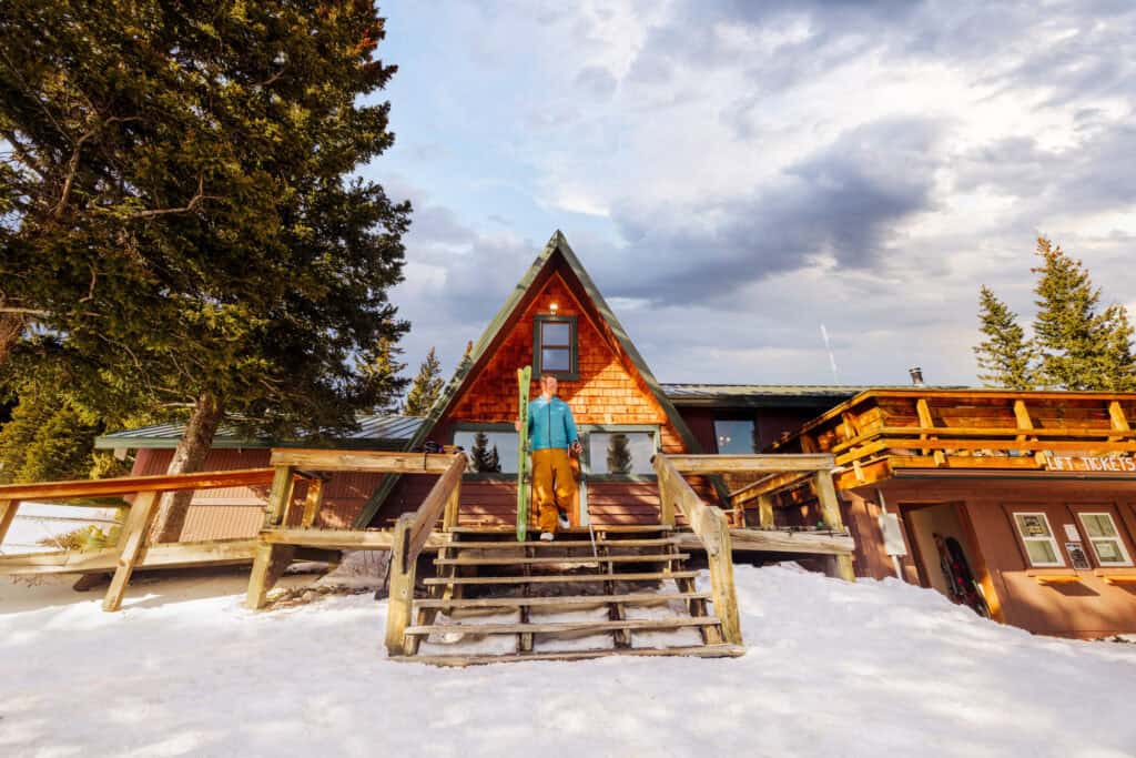 Chuck Hlavac walking down the steps of the lodge at Teton Pass