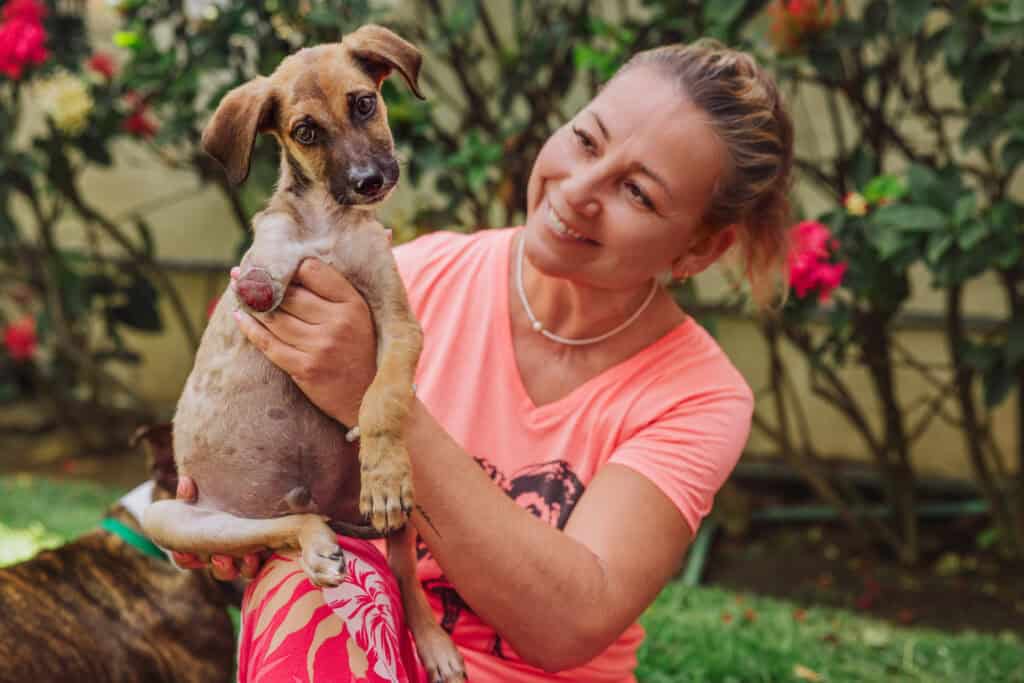Jessica Garibay, who founded the A Dog's New Life rescue group in Mexico. She's with Tre, a dog that lost its leg.