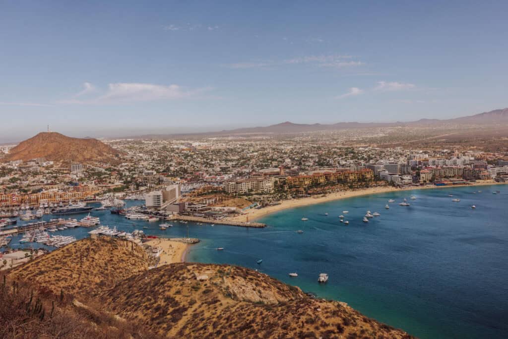An aerial drone view of Cabo San Lucas, the Sea of Cortez, and the marina