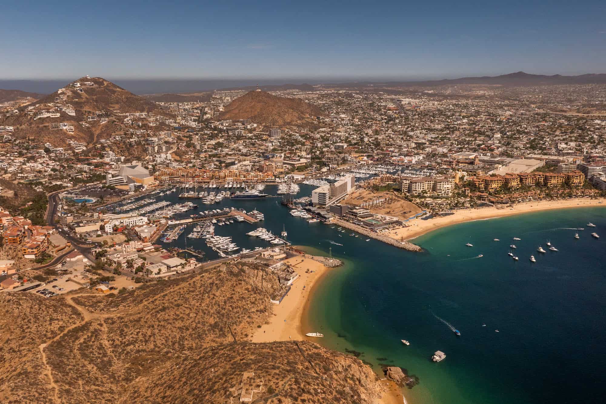 An aerial drone view of Cabo San Lucas, the marina, and the city