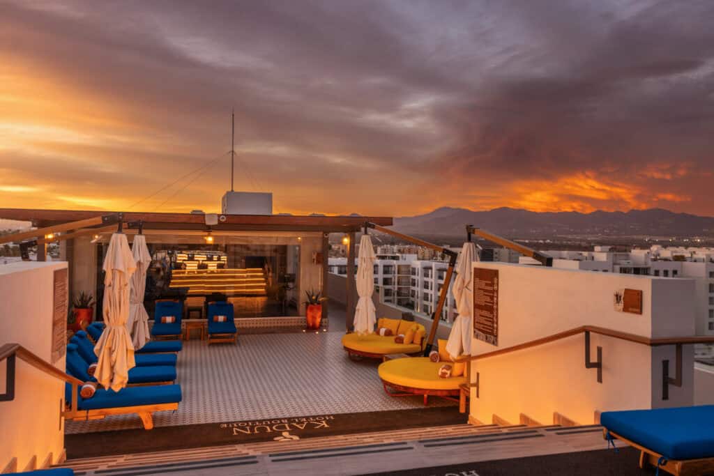 The lounge chairs on the Kadun rooftop at sunset