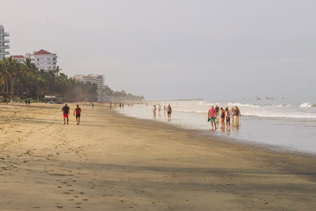 People walking along the beach in front of Marival Distinct resort in Nuevo Nayarit