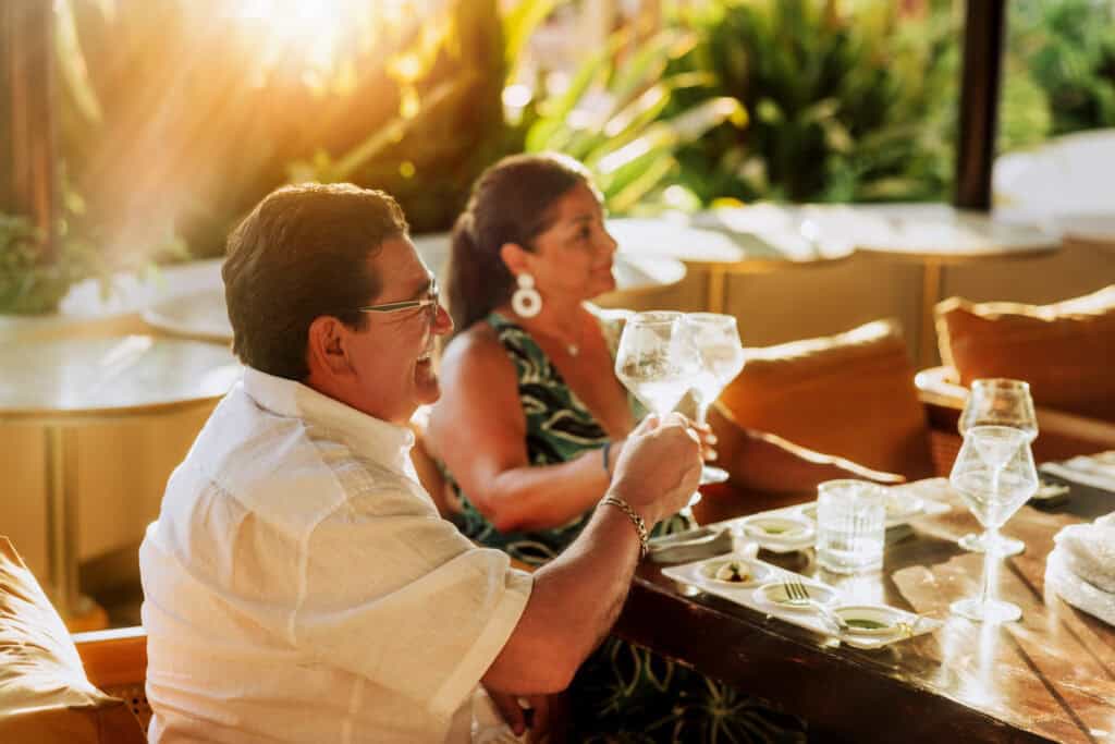 A California couple enjoying the wine tasting by the pool at Marival