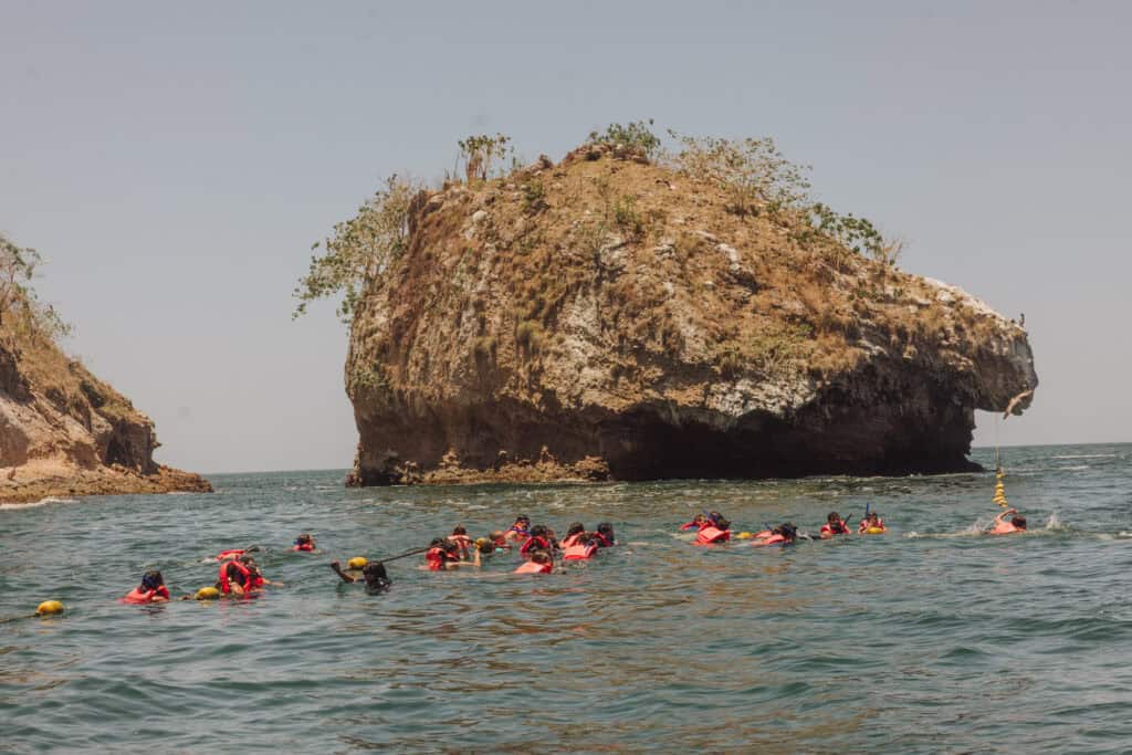 People snorkeling off Los Arcos