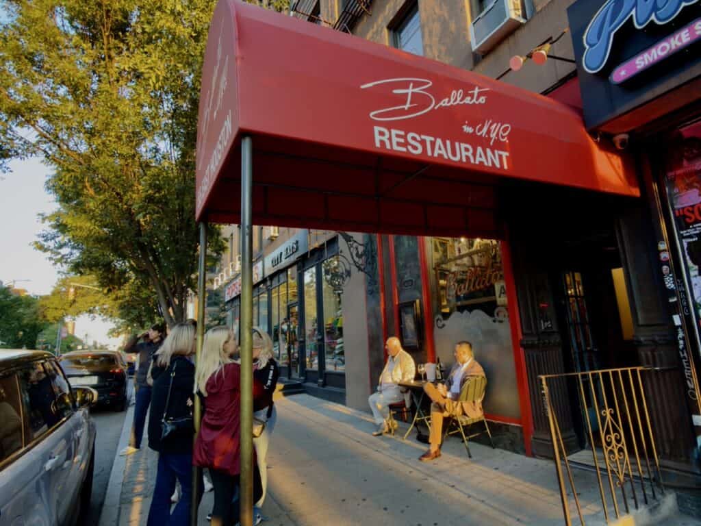 The exterior of Emilio's Ballato Italian restaurant and the line of people waiting in SoHo